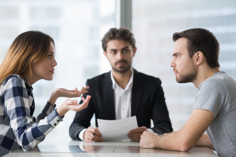 Annoyed married couple arguing in a lawyer’s office in Orange County, CA while discussing divorce options with Level Dispute Resolution